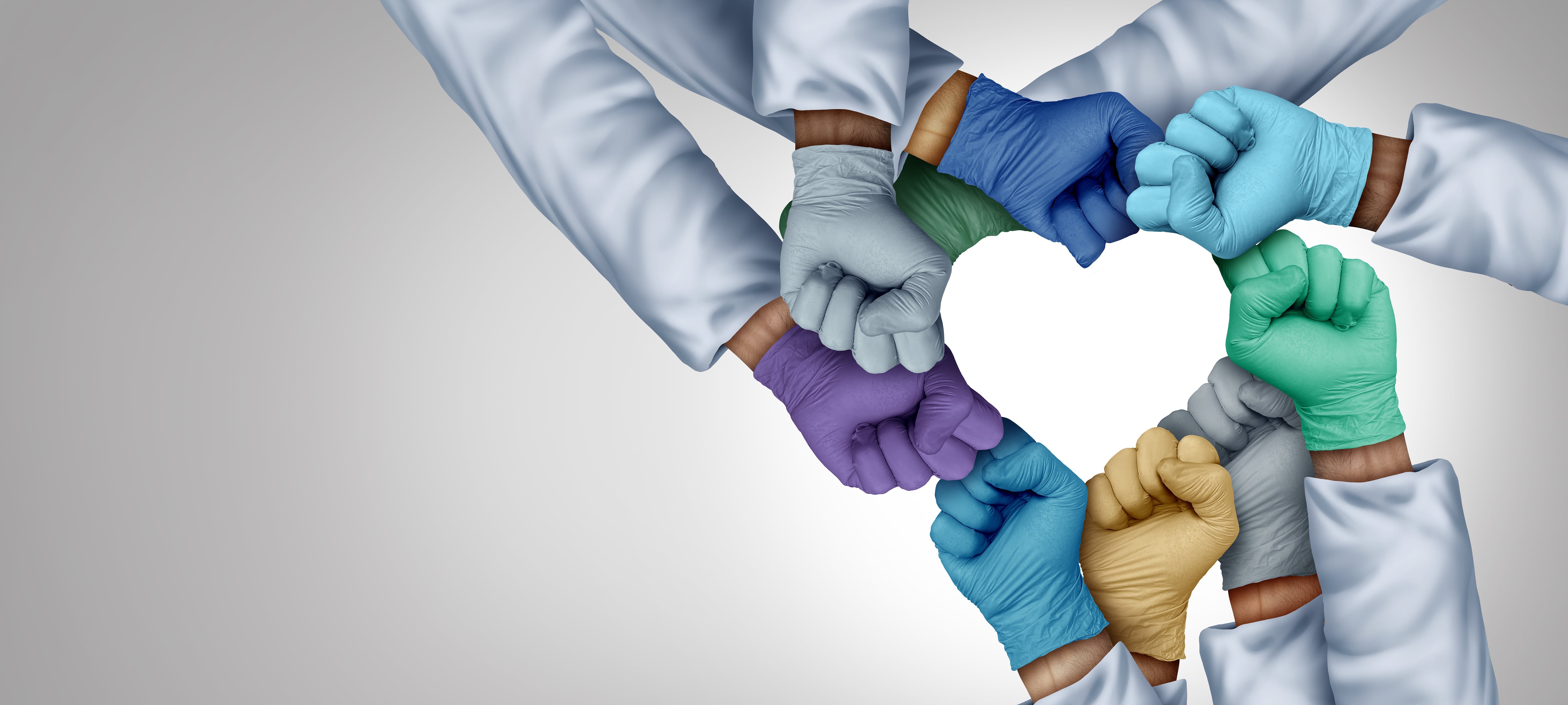 doctors wearing gloves forming a heart.